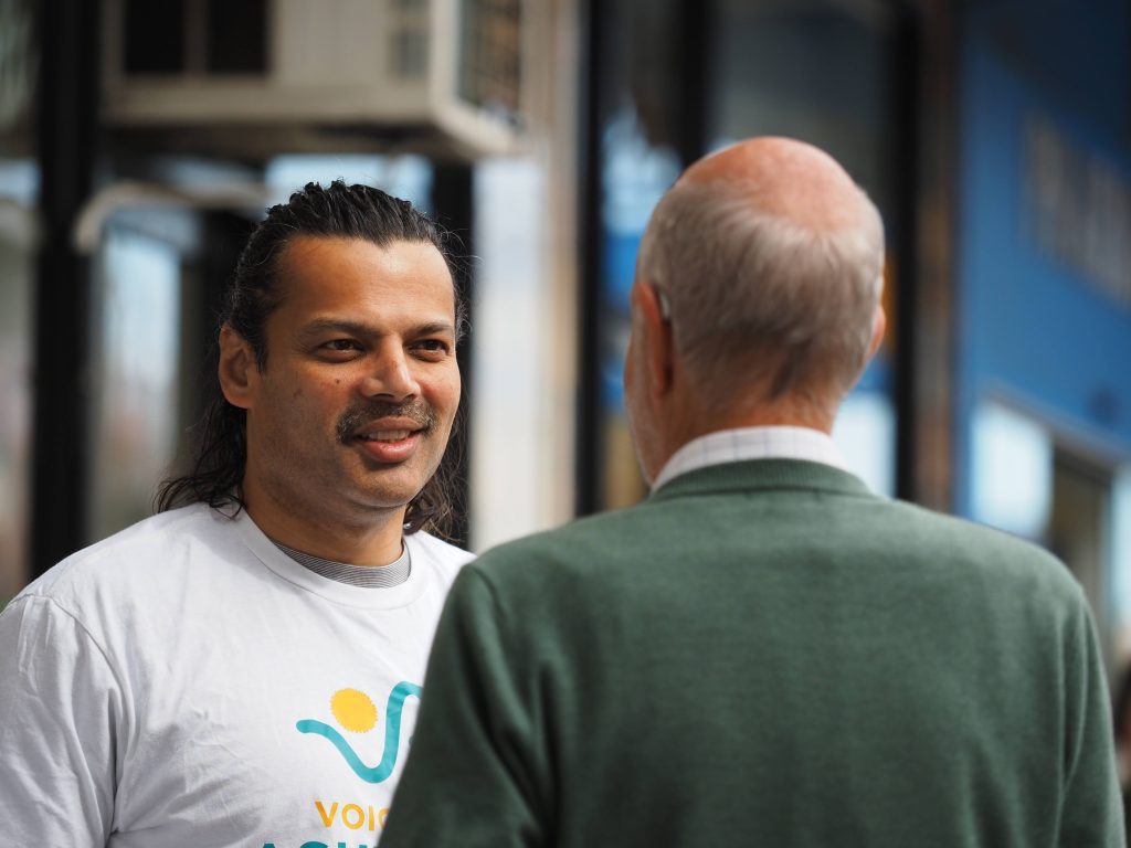 Hitendra listening to a community member