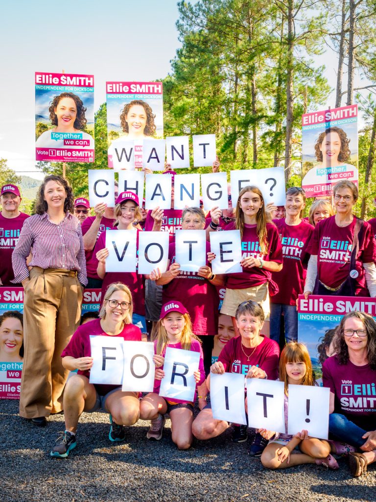 Community members holding signs supporting the campaign