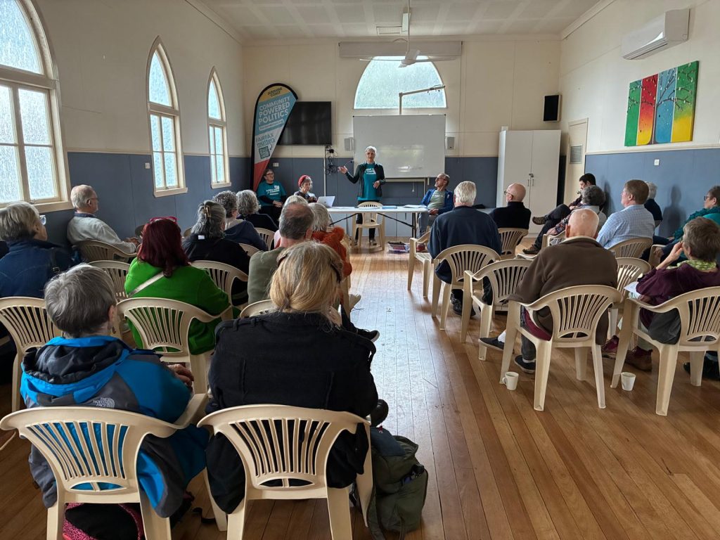 Linda Taylor addressing attendees seated in St Mark's Anglican Church Hall, Buderim, at the Fairfax Matters 2026 AGM