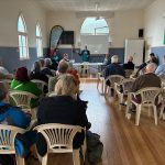 Linda Taylor addressing attendees seated in St Mark's Anglican Church Hall, Buderim, at the Fairfax Matters 2026 AGM