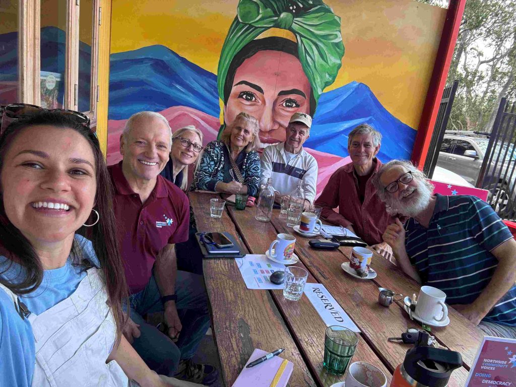 Tyler Miscannon having coffee with NCV volunteers at a cafe in Samford