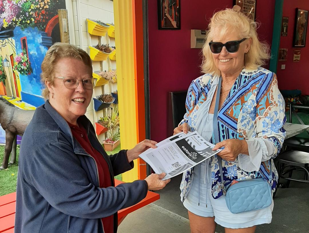 Membership prize winner being presented with tickets